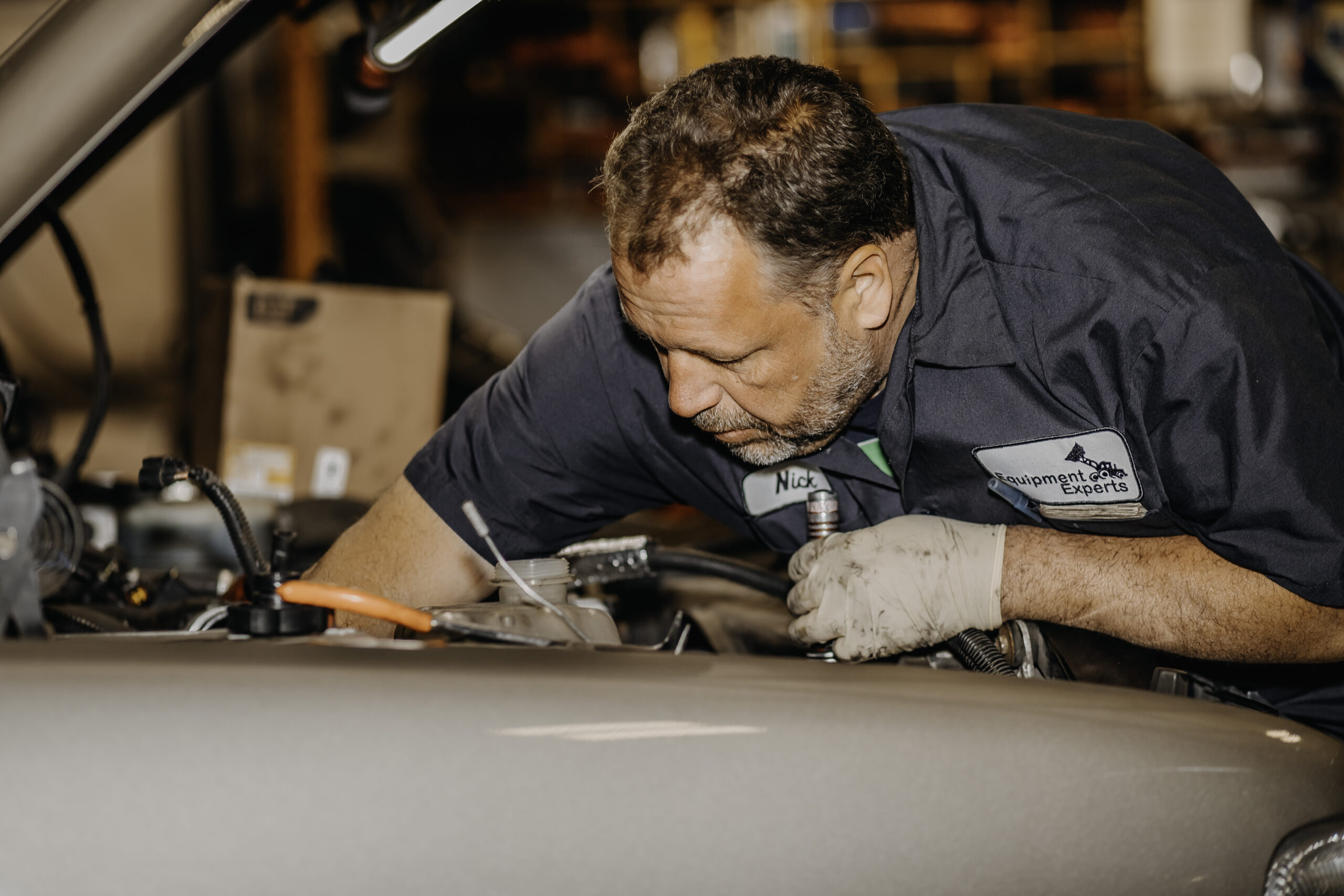 A man working in the guts of a vehicle