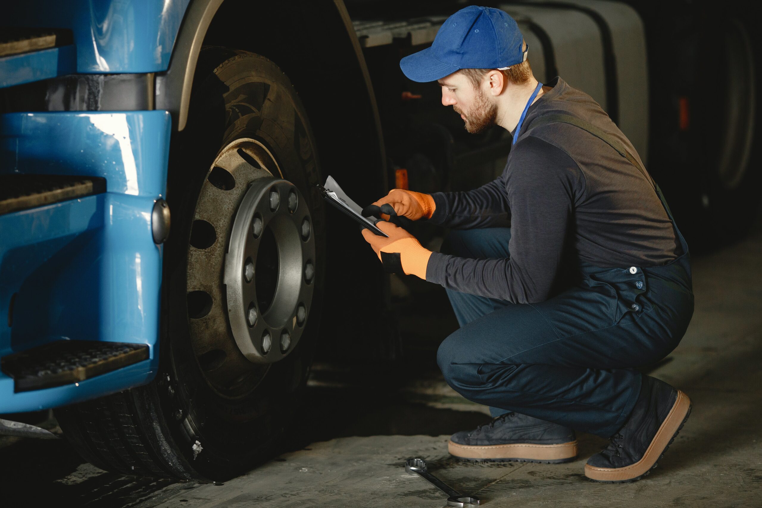 A mechanic checking a tire with a tool