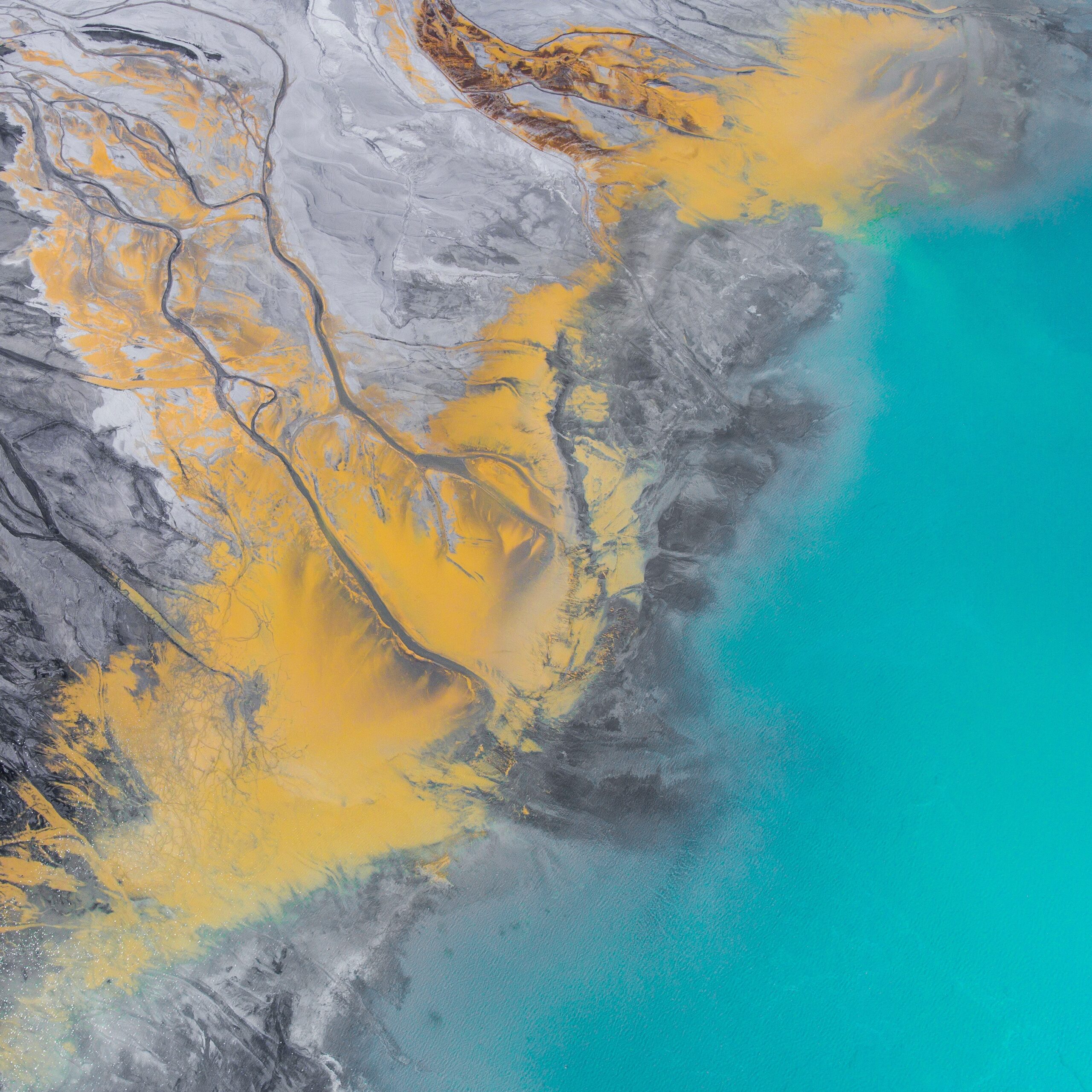 A multi-colored liquid oil spill