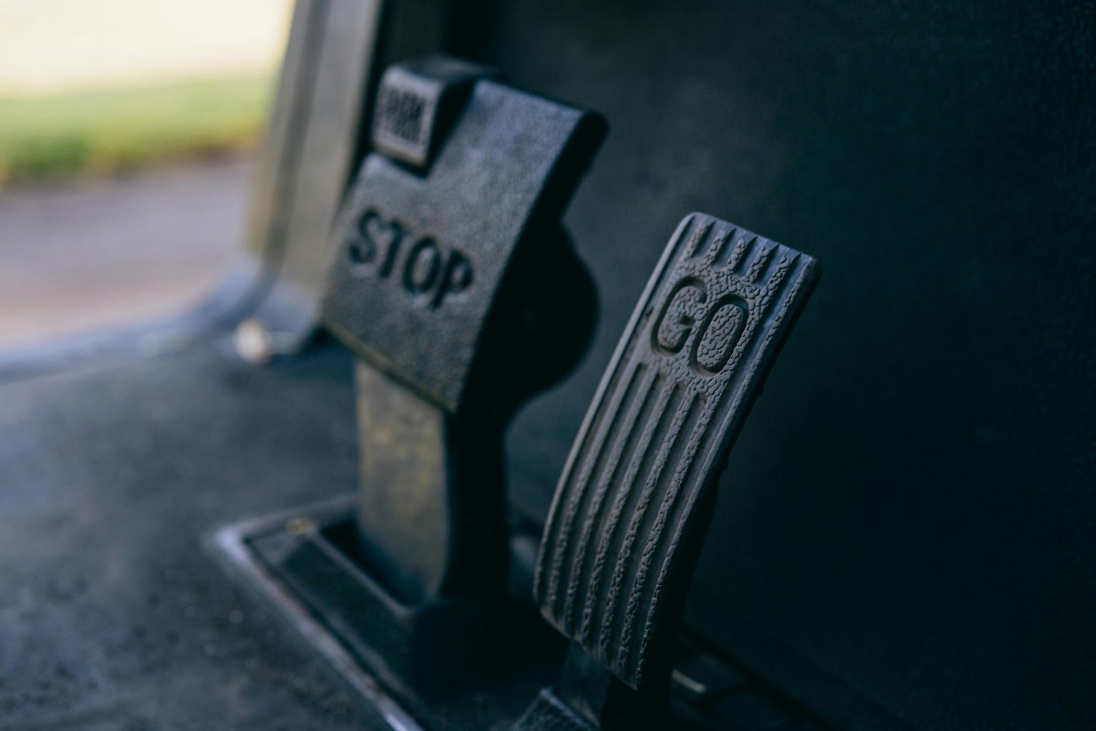 A close-up picture of a "Stop" and "Go" floor pedal on a forklift