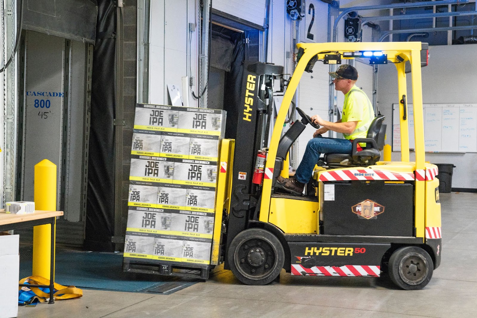 A class-IV forklift lifting crates of IPA beer