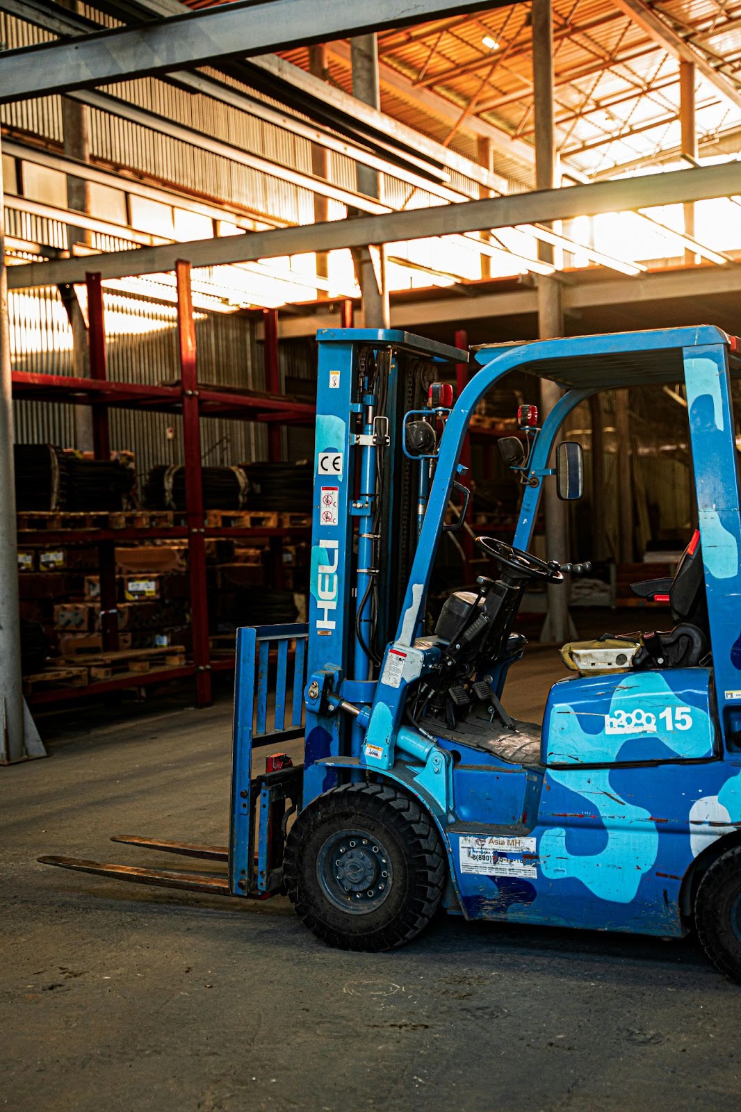 A blue and white forklift inside of a warehouse