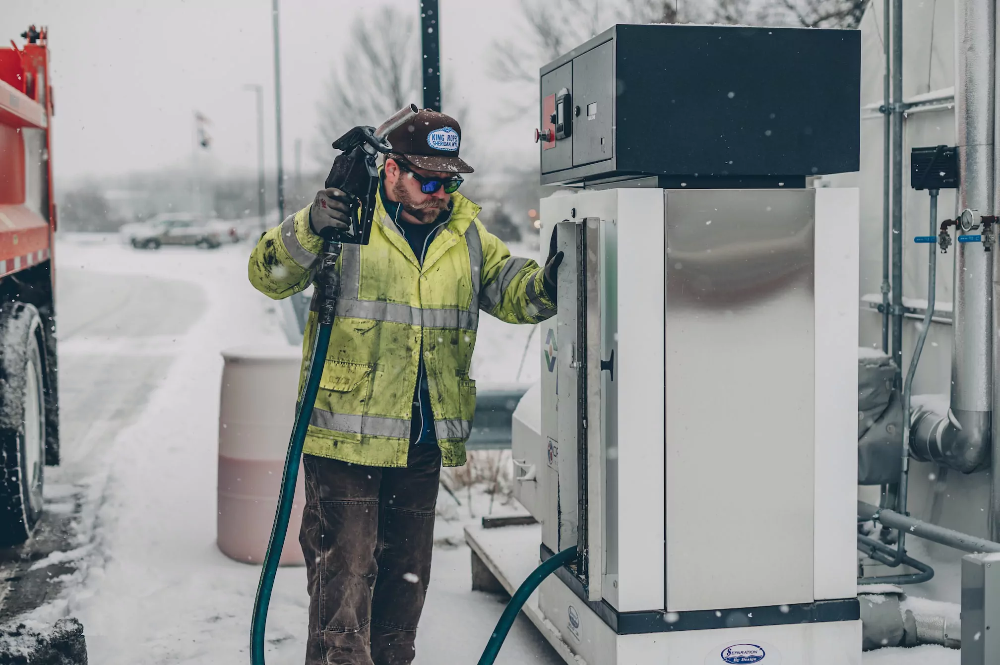 Truck driver fills his truck with gas