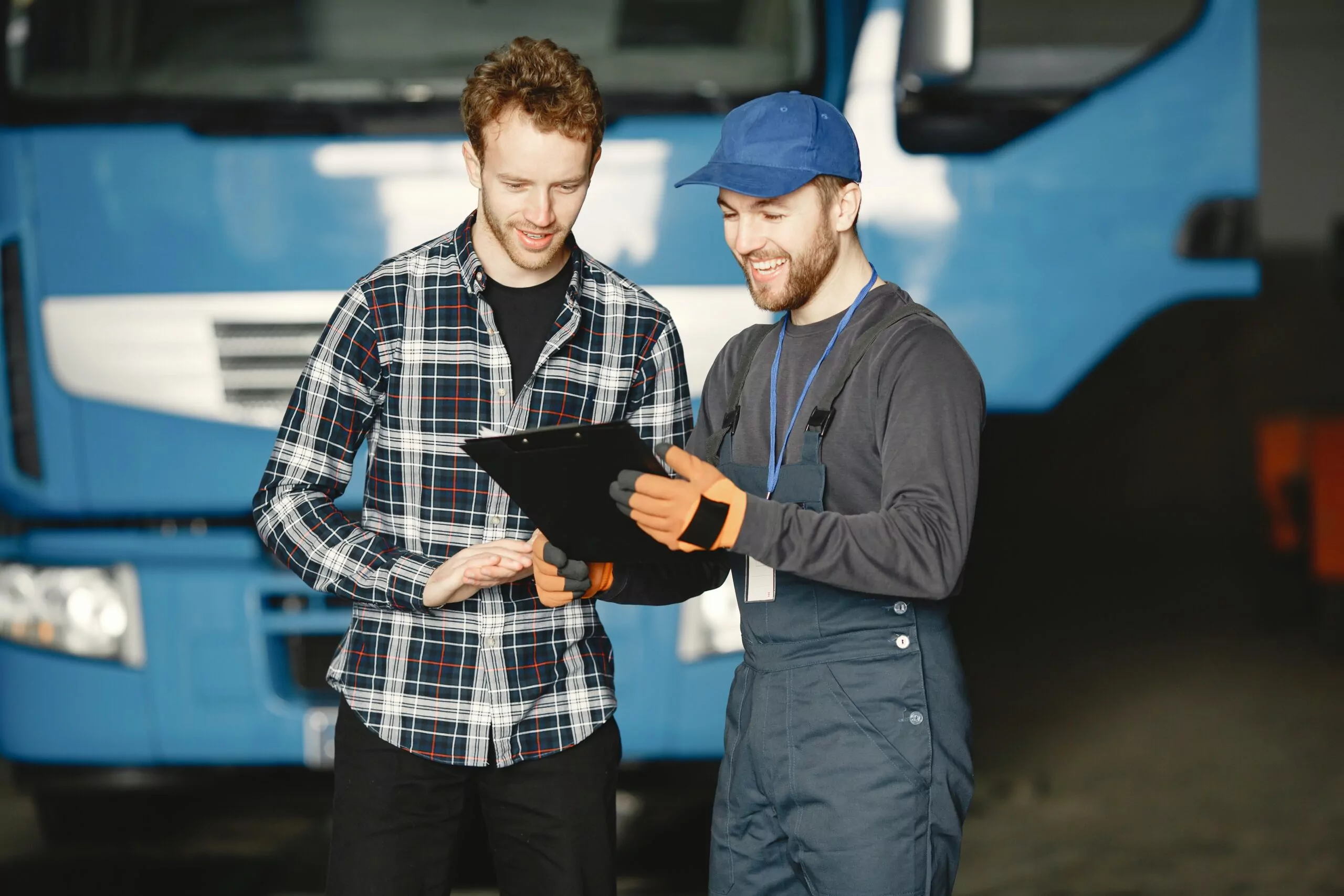 A maintenance technician helping an owner of a vehicle