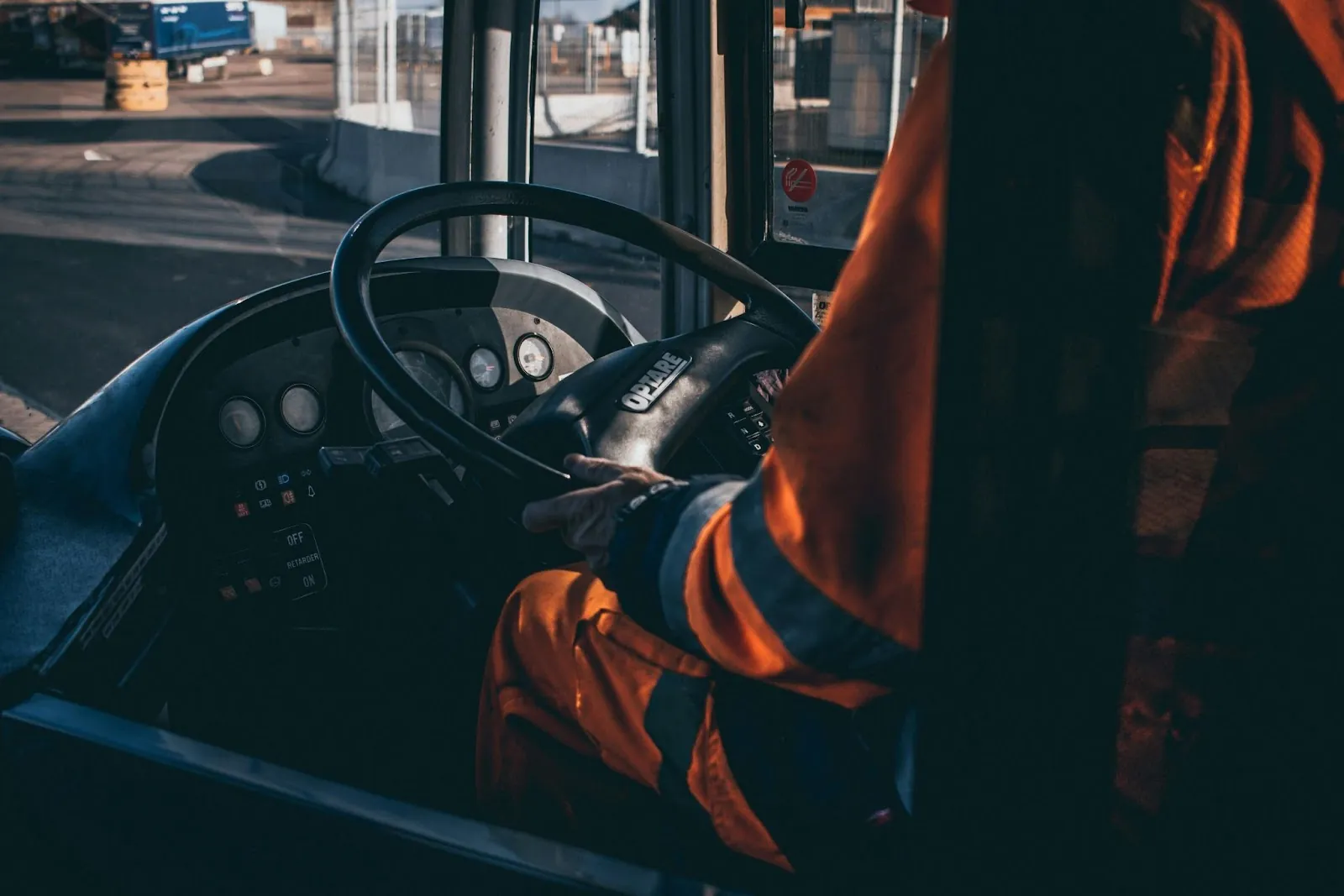 A picture of someone's hands on a forklift wheel